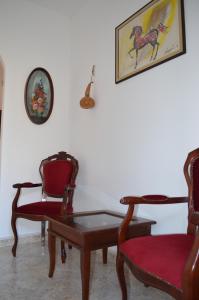 a living room with two chairs and a table at la casa di sotto in Alpignano