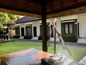 a table with a teddy bear sitting on top of it at The Celuk Homestay in Jimbaran