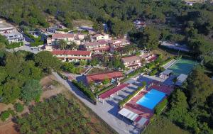 an aerial view of a house with a tennis court at Residence La Valdana in Capoliveri