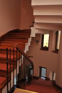 a staircase in a home with wooden railings at Pensiunea Kenza in Târgu-Mureş