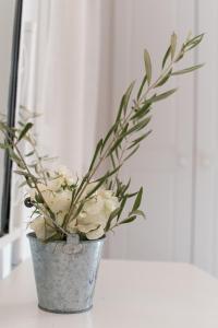 a vase filled with white flowers sitting on a table at Krotiri Bay -adults only in Parikia