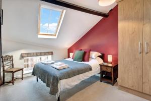 a attic bedroom with a bed and a window at The Old Sweet Factory in Harrogate