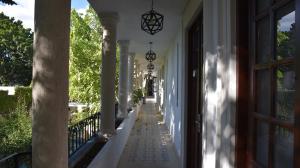 a hallway of a white house with a window at Hotel Zamna Boutique in Mérida