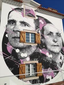 a mural of a man on the side of a building at Casa do Joaquim da Praia in Nazaré