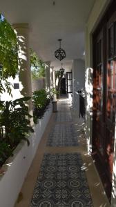 a hallway of a house with a tile floor at Hotel Zamna Boutique in Mérida