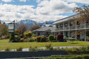 un hotel con montagne sullo sfondo di Lakeside Motel & Apartments a Te Anau