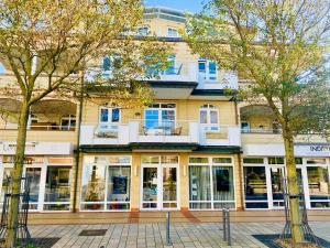 a large building with windows and trees in front of it at Sellminchen Sylt in Westerland (Sylt)