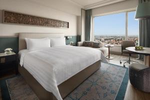 A bed or beds in a room at Shangri-la Surabaya