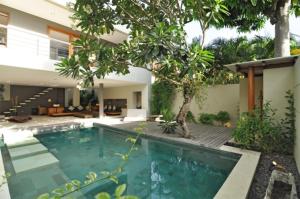 a swimming pool in the backyard of a house at Villa Athena in Seminyak