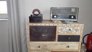 a wooden dresser with a radio on top of it at SEA URCHIN MILFONTES by Stay in Alentejo in Vila Nova de Milfontes