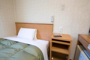 Кровать или кровати в номере Hotel Econo Yokkaichi