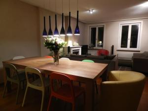 a living room with a wooden table and chairs at Apartment Het Blekershuys in Bruges