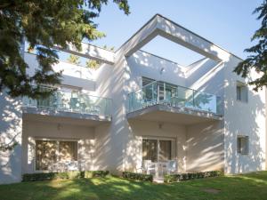 a white house with a balcony at Crvena Luka Resort in Biograd na Moru