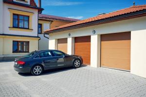 a blue car parked in front of a house at Vila Encore in Valašské Meziříčí