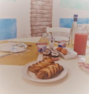 a plate of pastries and eggs on a table at Locanda del Sole Nero in San Terenzo