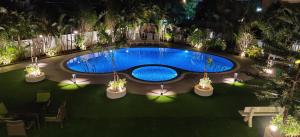 an overhead view of a swimming pool at night at Meritas Adore Resort in Lonavala