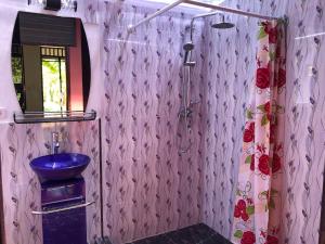 a bathroom with a blue sink and a shower at The Papalagi Resort in Gili Gede