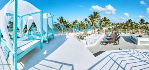 a deck of a cruise ship with palm trees at Dream Punta Cana Beachfront Apartment - 4-Bedroom Penthouse with Rooftop BBQ & Ocean Views in Punta Cana