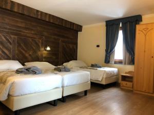 Rúm í herbergi á Hotel Edelweiss 3 Stelle SUPERIOR