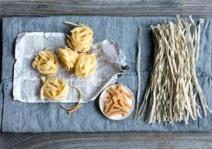 un montón de pasta en una mesa al lado de los palos en Castello del Sole Beach Resort&SPA, en Ascona