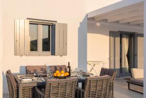 a dining room with a table and chairs at PAROS ELITAS VILLAS in Parikia