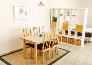 a dining room with a wooden table and chairs at Boarding-Potsdam in Potsdam