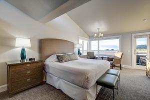 um quarto com uma cama, uma secretária e uma mesa em The Waves em Cannon Beach