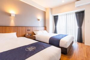 A bed or beds in a room at LAPIN MIHAMA Residence Hotel