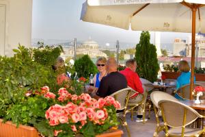 a group of people sitting at a table with flowers at White House Hotel Istanbul in Istanbul