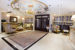 a living room with a chandelier and a rug at White House Hotel Istanbul in Istanbul