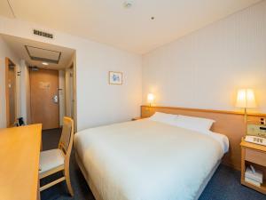 Gulta vai gultas numurā naktsmītnē Hotel Grand Terrace Obihiro