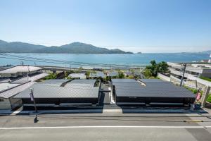 een parkeerplaats met uitzicht op het water bij 宮島離れの宿 IBUKU 別邸 -Miyajima Hanarenoyado IBUKU Bettei- in Ōno