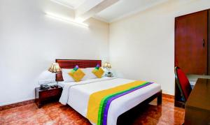 Una cama o camas en una habitación de Itsy Hotels Ammu Regency