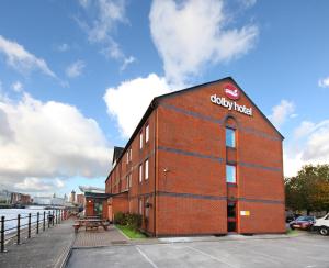 un edificio di mattoni rossi con un cartello aziendale di The Dolby Hotel Liverpool - Free city centre parking a Liverpool