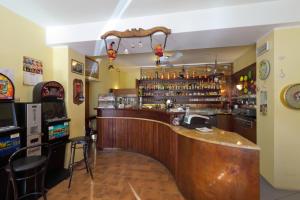 a bar with a wooden counter in a restaurant at Albergo Alle Alpi in Comeglians