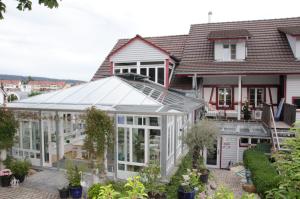 an or greenhouse in front of a house at BnB zum Schlüssel in Unterehrendingen