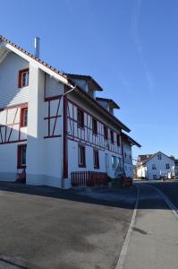 a white building on the side of a street at BnB zum Schlüssel in Unterehrendingen