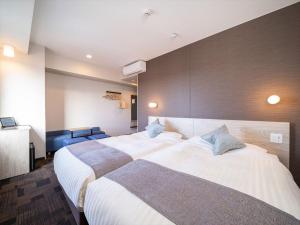 Ліжко або ліжка в номері Super Hotel Premier Saitama Higashiguchi