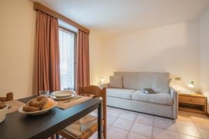 a living room with a couch and a table at Residence Fior d'Alpe in Bormio