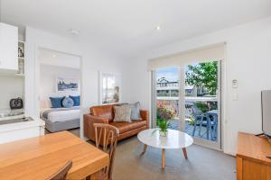 een woonkamer met een bank en een tafel bij The Victoria Apartments in Port Fairy