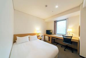 大阪Hotel Granvia Osaka-JR Hotel Group的酒店客房配有一张床和一张带电脑的书桌