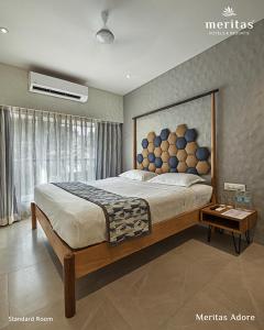 a bedroom with a large bed and a window at Meritas Adore Resort in Lonavala