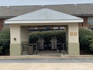 a pavilion with tables and chairs in front of a building at Candlewood Suites Jonesboro, an IHG Hotel in Jonesboro