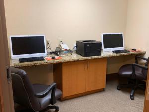 a desk with two computers on top of it at Candlewood Suites Jonesboro, an IHG Hotel in Jonesboro