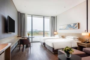 Tempat tidur dalam kamar di Hyatt Place Changsha Airport