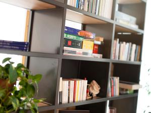 a book shelf filled with lots of books at Red Fox Lodge in Breuil-Cervinia