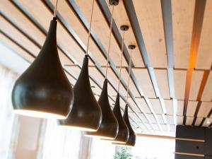 a row of light fixtures hanging from a ceiling at Red Fox Lodge in Breuil-Cervinia