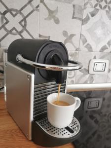 a cup of coffee being poured into a coffee machine at Aura Apartment - Ski In & Ski Out - Cerviniaholidays-com in Breuil-Cervinia