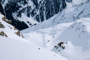 eine Gruppe von Menschen, die einen schneebedeckten Berg hinunterfahren in der Unterkunft Hôtel Chalet Royal in Veysonnaz