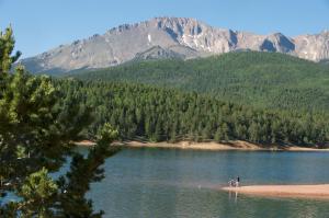 two people standing on the shore of a lake with mountains at Holiday Inn Express & Suites Colorado Springs North, an IHG Hotel in Colorado Springs